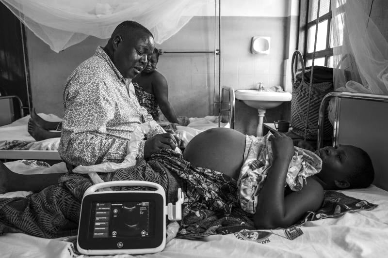 A pregnant woman being treated by a doctor at a hospital