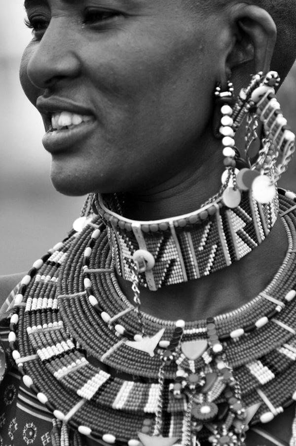 A Maasai woman wearing multi-colored beauty accessories