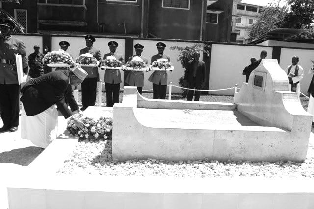 Soldiers and other dignitaries praying at Abeid Karume's grave