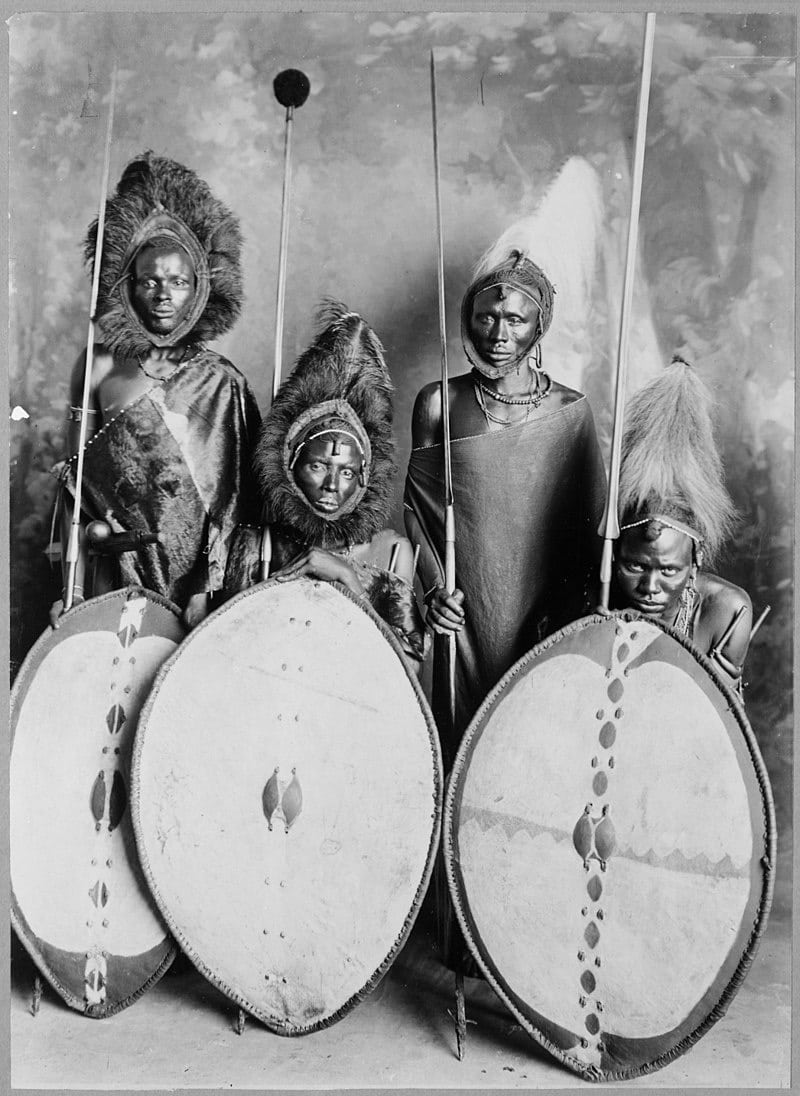 Four Maasai warriors in full armor