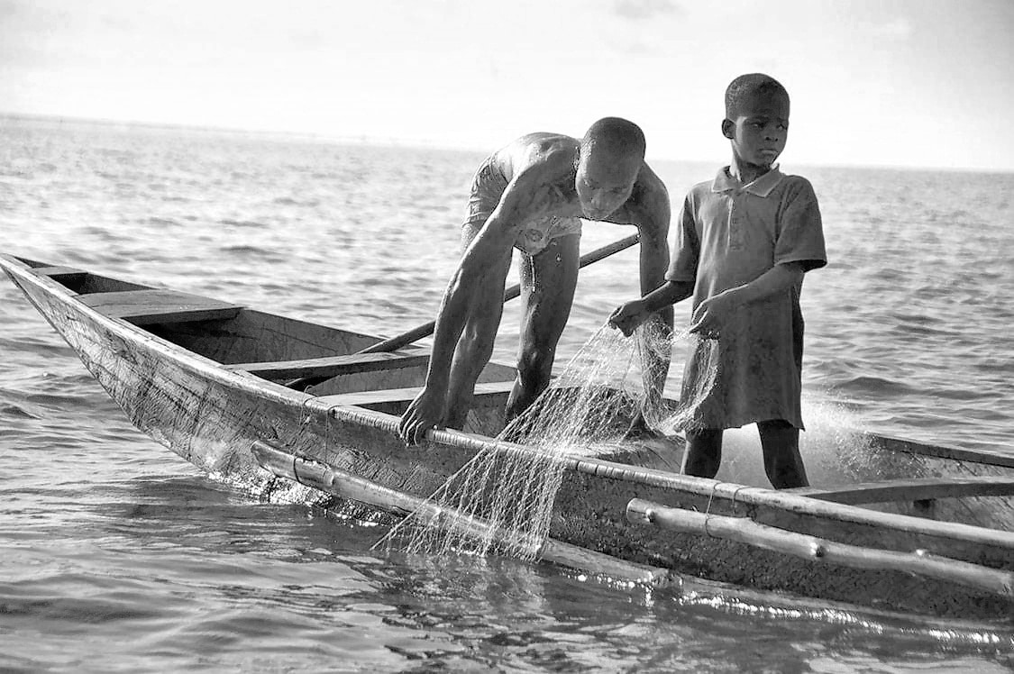Children fishing to earn a living