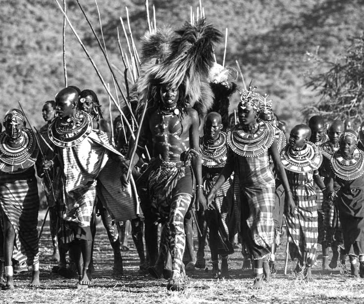 Maasai warrior being escorted during the warrior ceremony