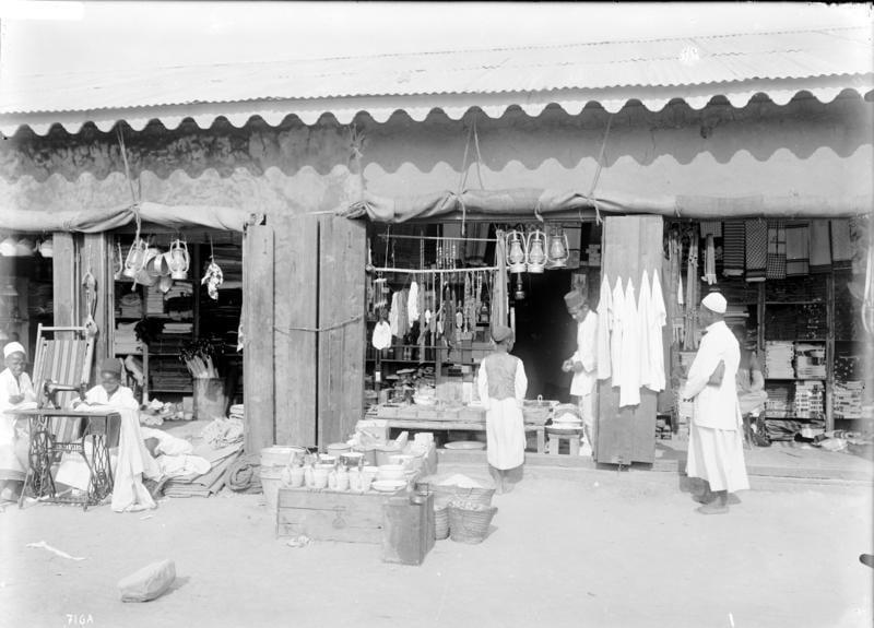 Shops owned by Indians with people roaming around in year 1906