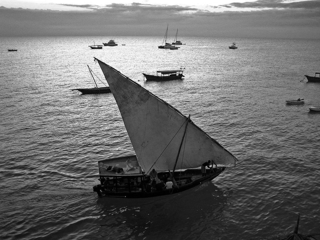 Tourists dhow boat sailing on Nungwi Beach waters in Zanzibar