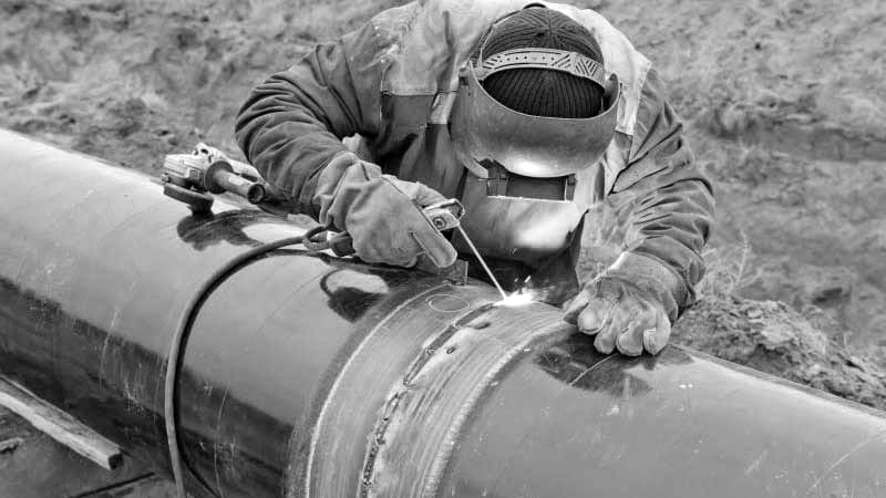 An engineer works on a gas pipe for Tanzania Petroleum