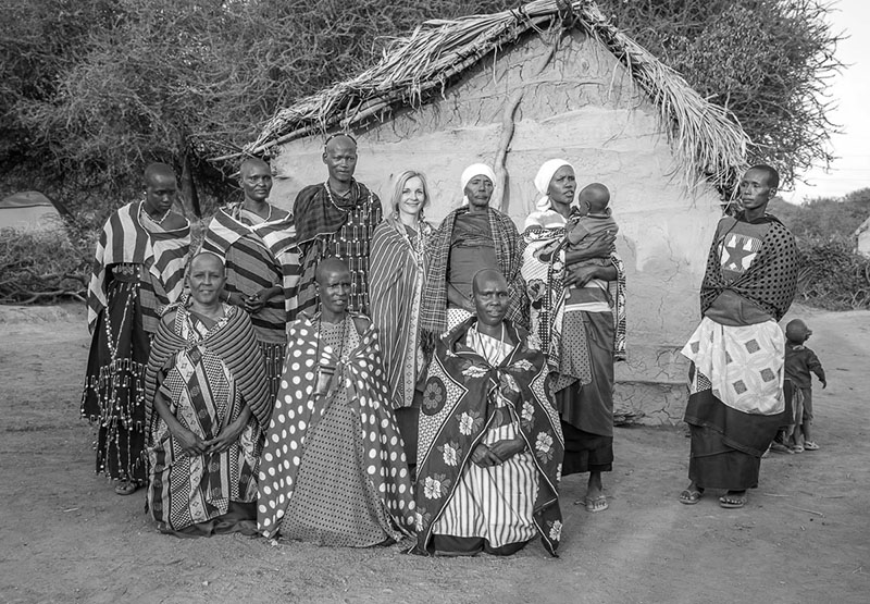 Anniina Sandberg posing with Maasai ladies while living at their Boma