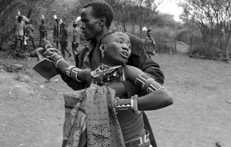 A man taking a girl by force to her husband after she attempted to flee