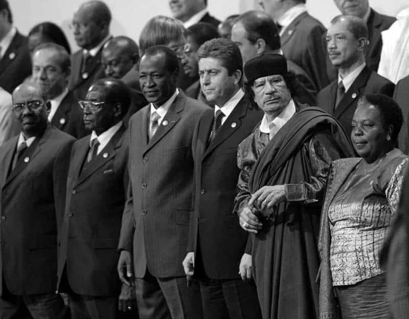 Gertrude standing next to Muammar Gaddafi