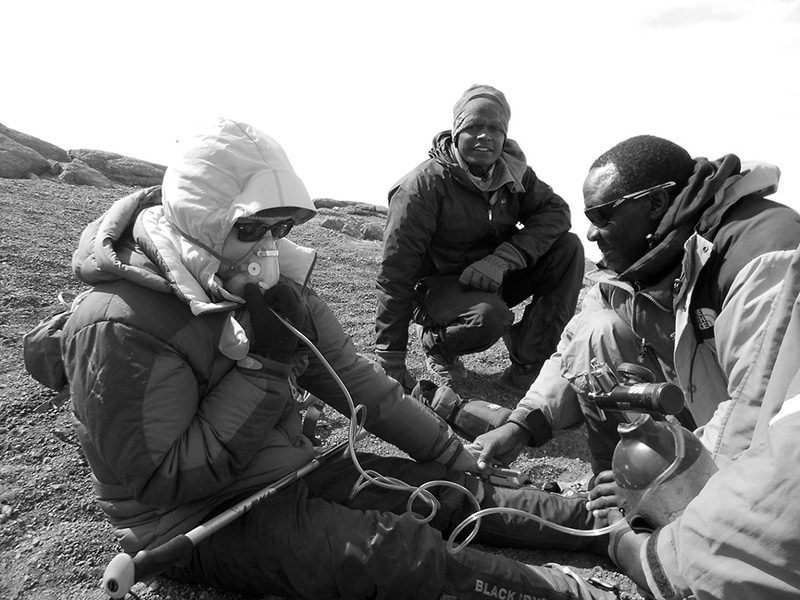 Climber getting oxygen assistance during Kilimanjaro expedition