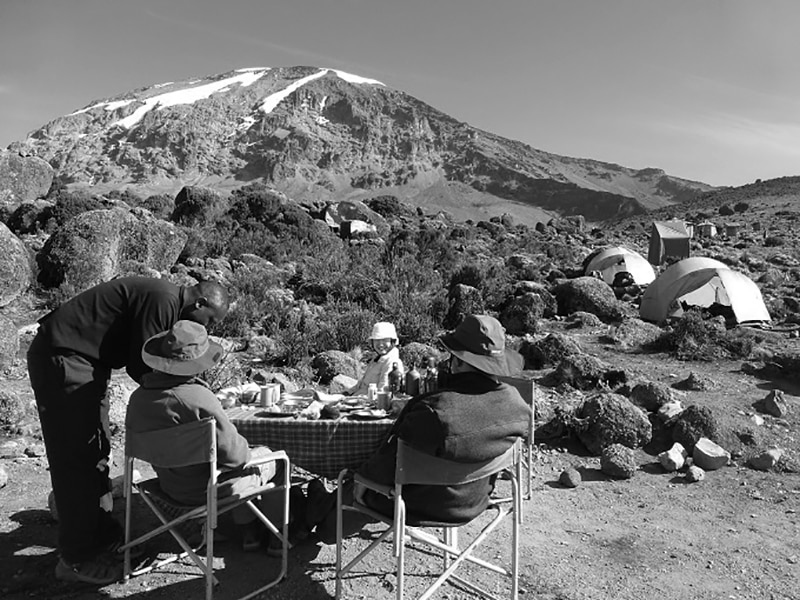 Climbers having a meal at one of the stops on their way up to Kilimanjaro summit