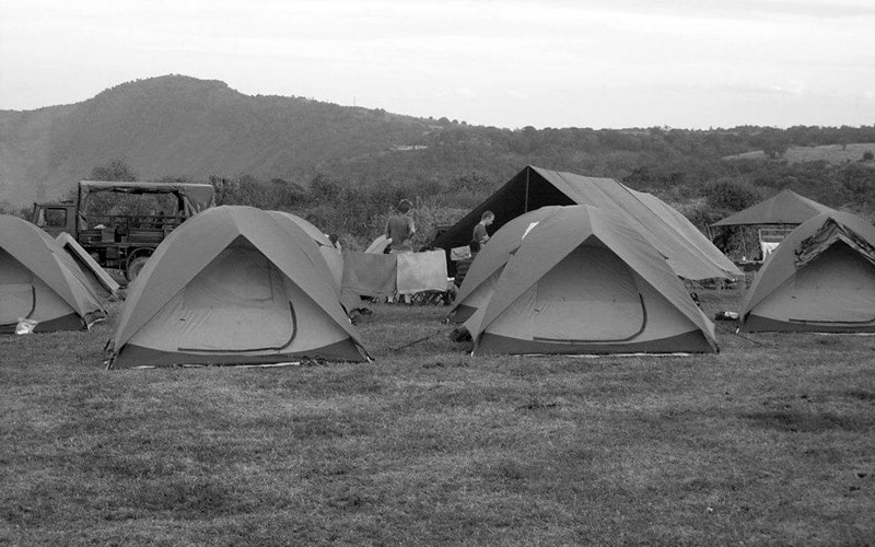 Camping safari in Tanzania - tents pitched near mountains