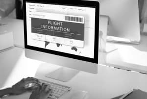 A Traveler checking flight info on a desktop
