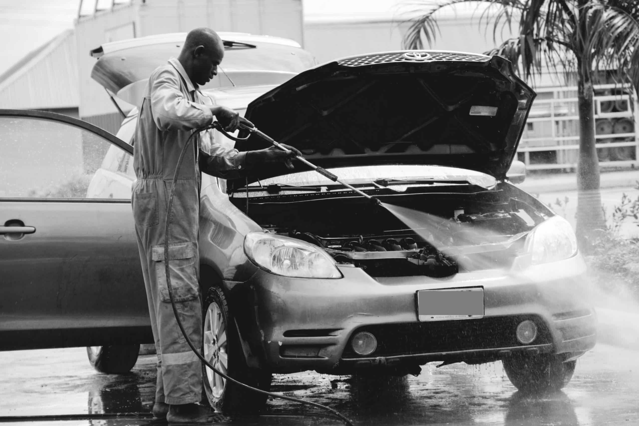 man washing car with car wash machine