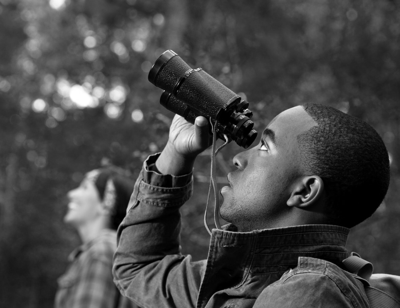 A Man Bird Watching with Binoculars