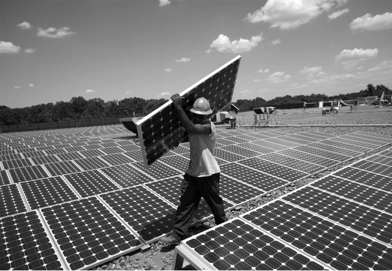 A man installing a Solar Panel
