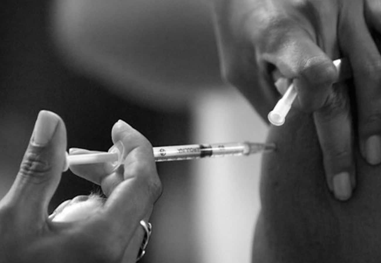 A woman taking a Vaccine..