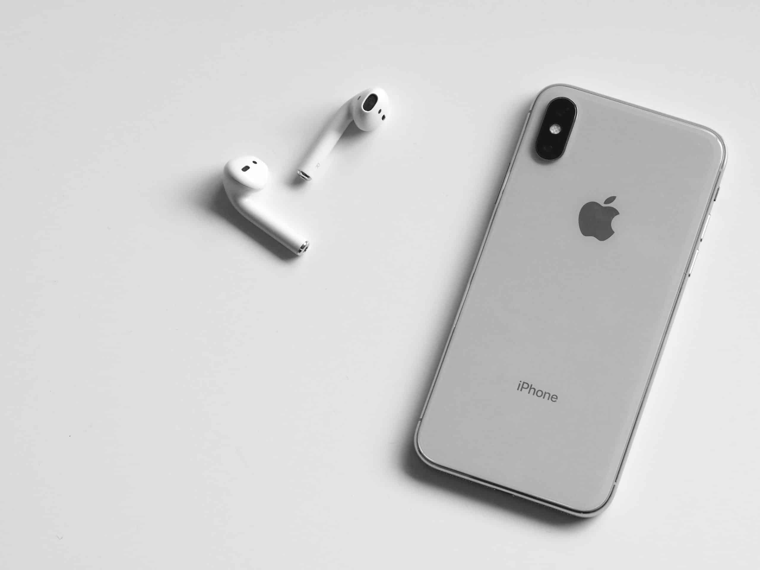 Back view of an iPhone XR next to Airpods