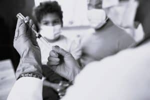 Nurse in medical glove preparing a vaccine