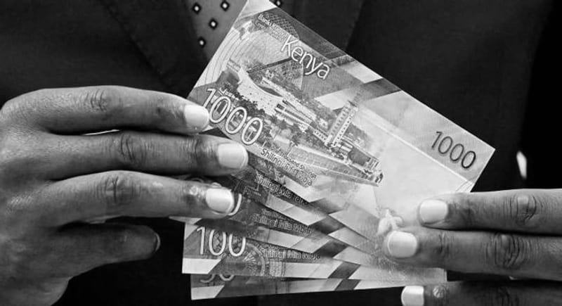 Man holding Kenya Shillings Notes