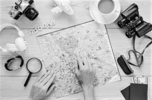 A Traveler Planning a trip by examining a map to a destination