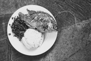Traditional East African food - ugali, fish and greens in Kenya