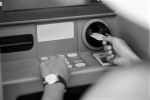 A Person Inserting card into an ATM Machine