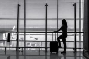 A Woman waiting for an airplane at airport terminal