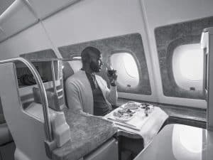 African male having lunch on Emirates Business Class