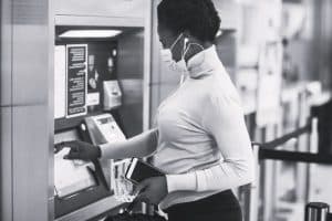 A lady Withdrawing local currency from ATMs